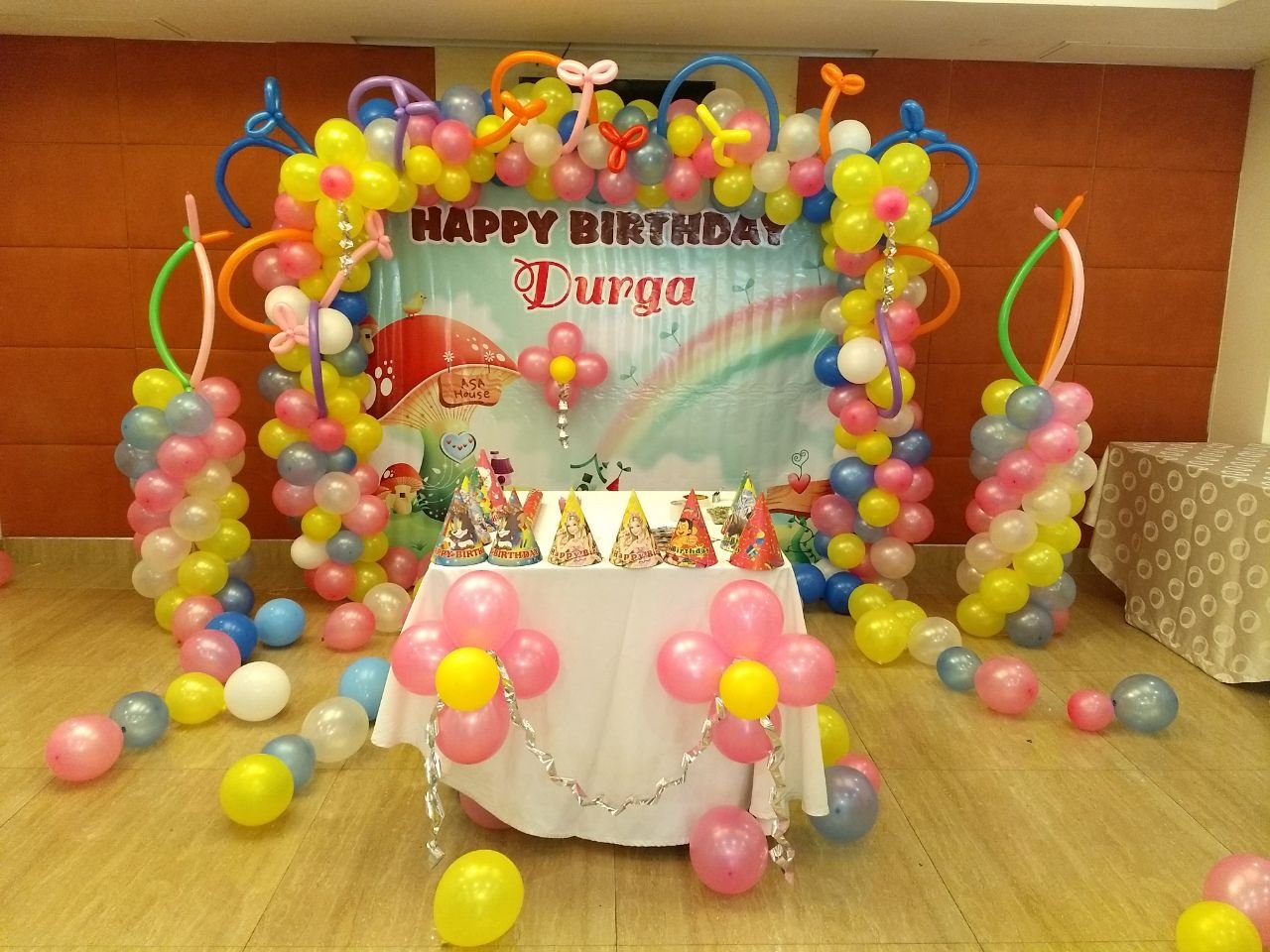 Rainbow theme banner birthday party balloon decorators Bangalore