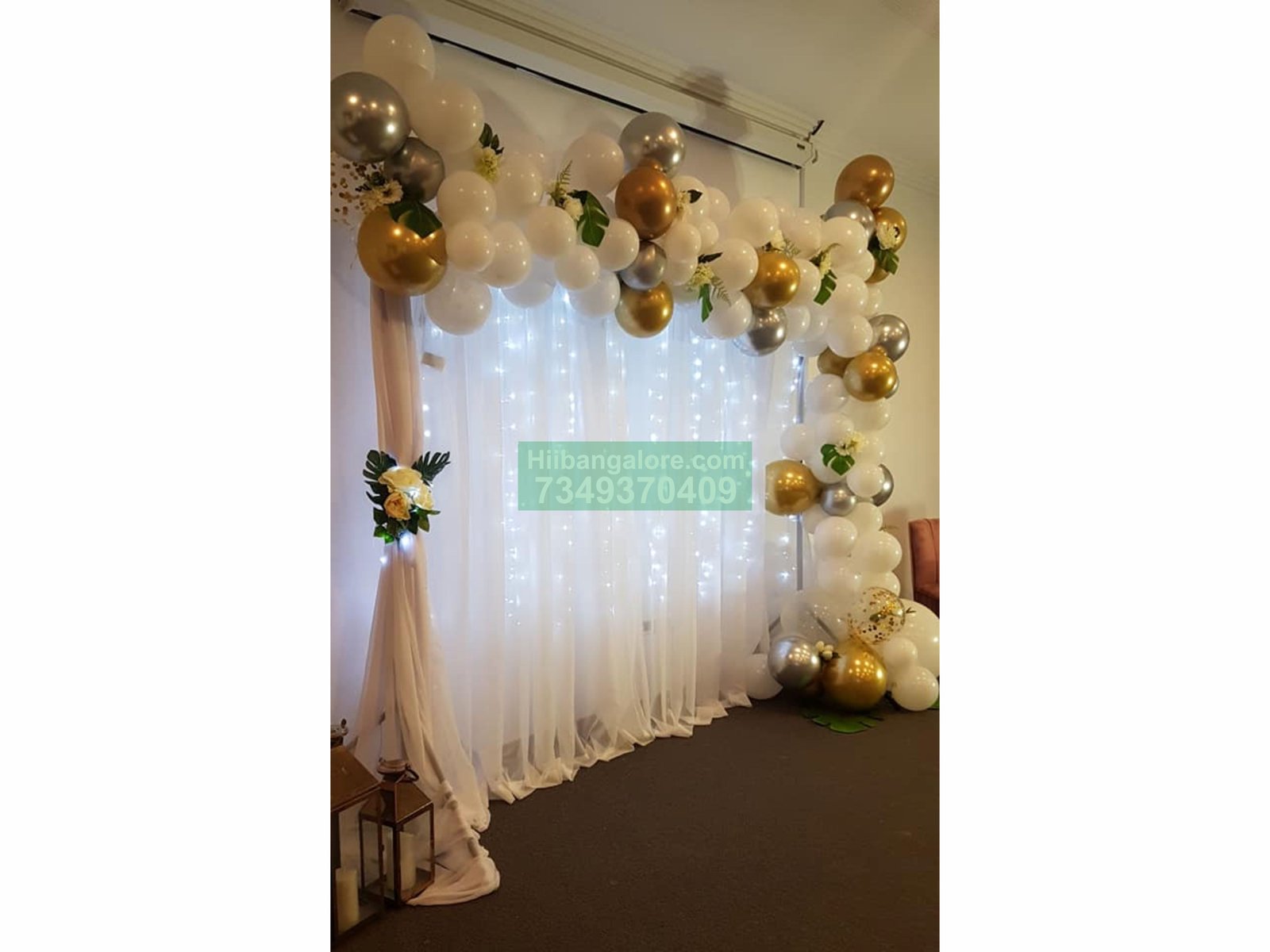 white backdrop and organic balloon arc decoration for engagement Bangalore