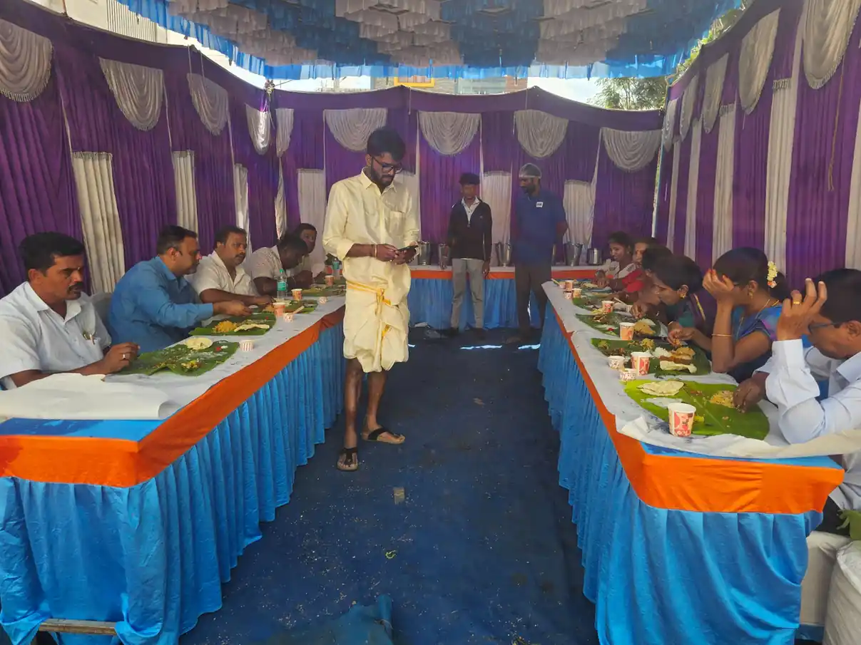 Long serving table with banana leaves and festive food setup