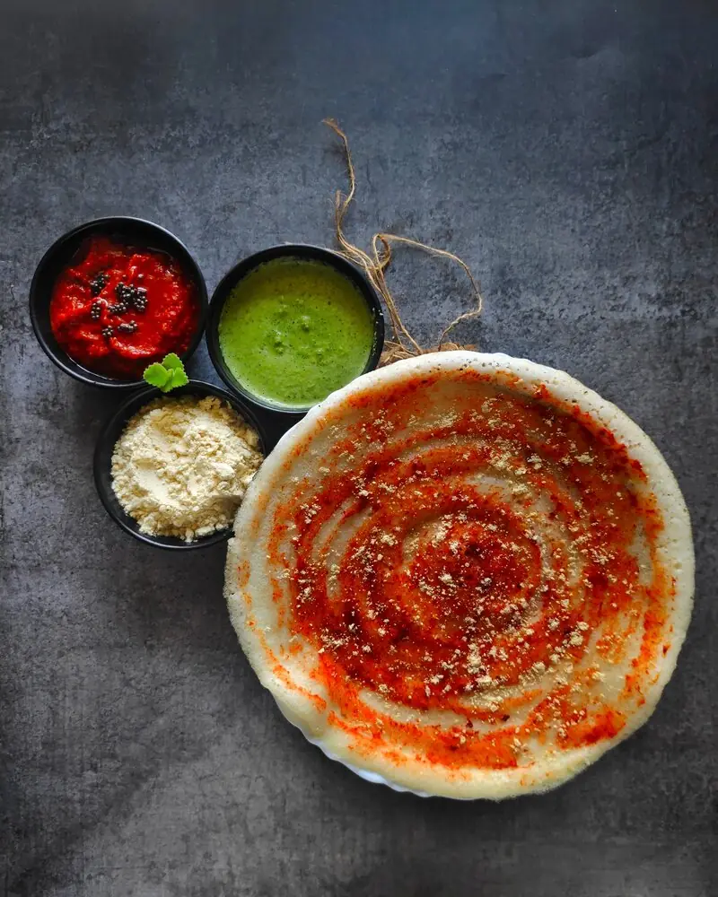 Spicy Andhra erra karam dosa served fresh by traditional catering service in Bangalore