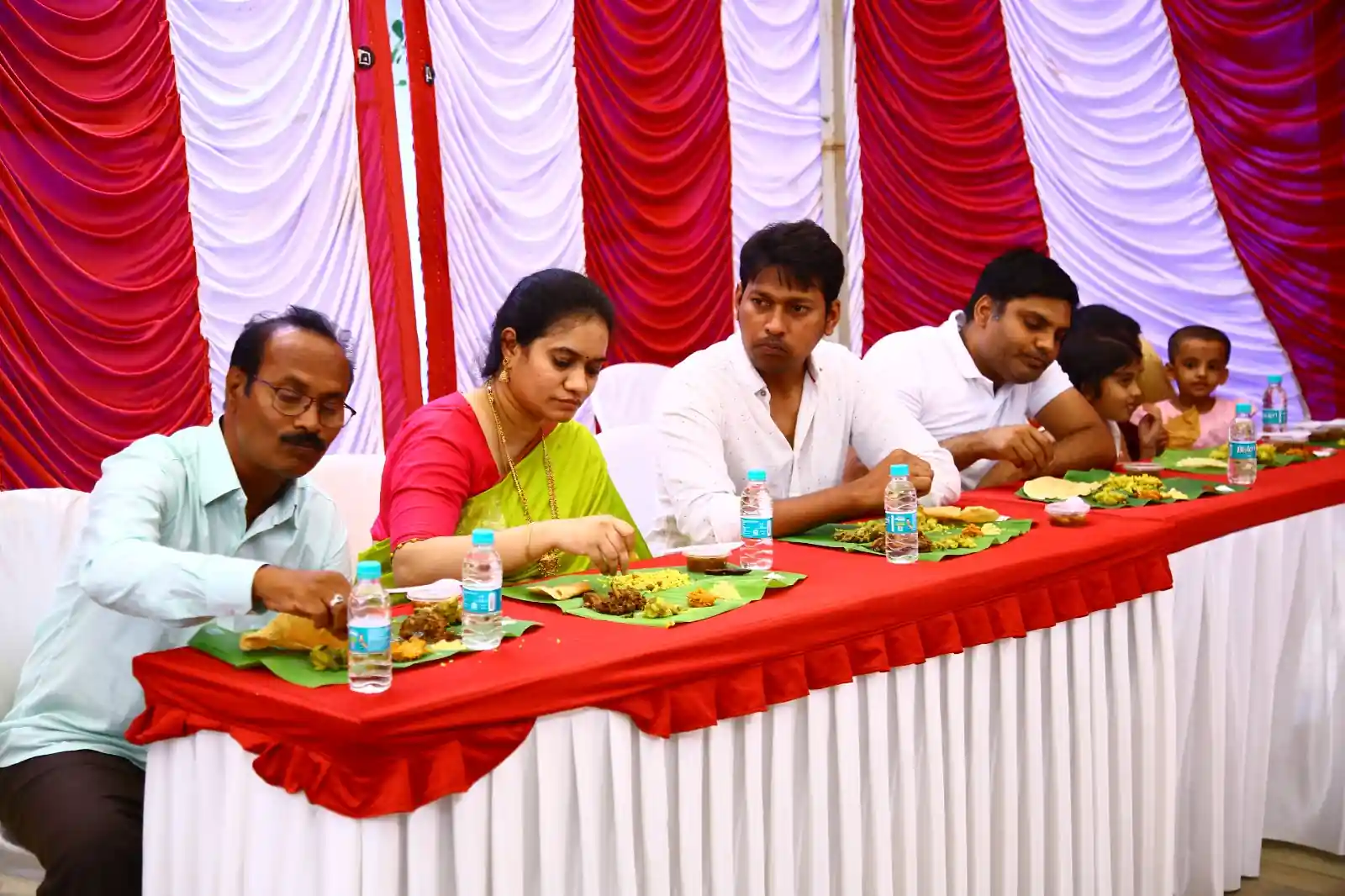 Wedding guests enjoying traditional Andhra wedding feast on banana leaves