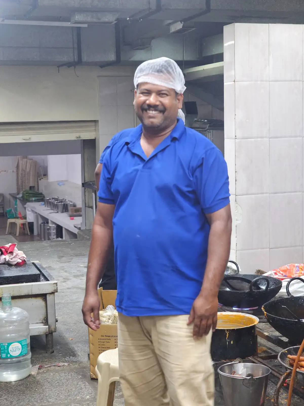 Expert Andhra style chef working in a professional catering kitchen