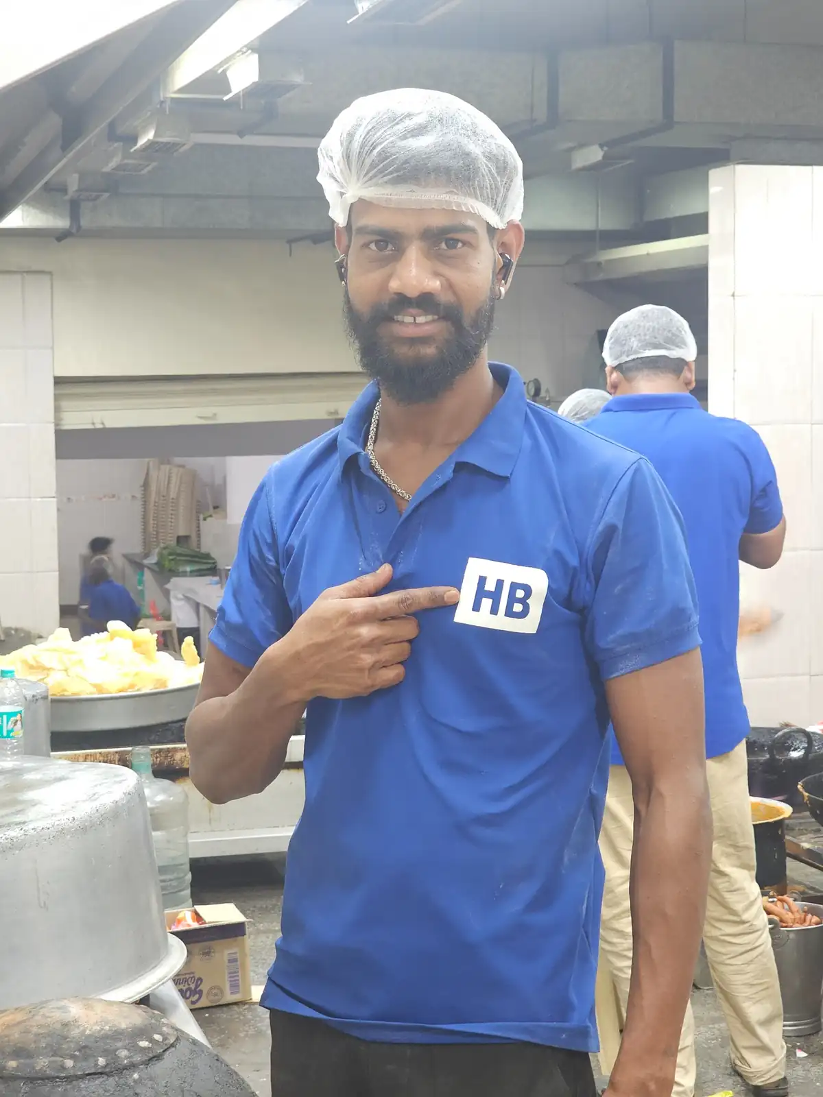 Professional Andhra catering chef wearing uniform inside commercial kitchen