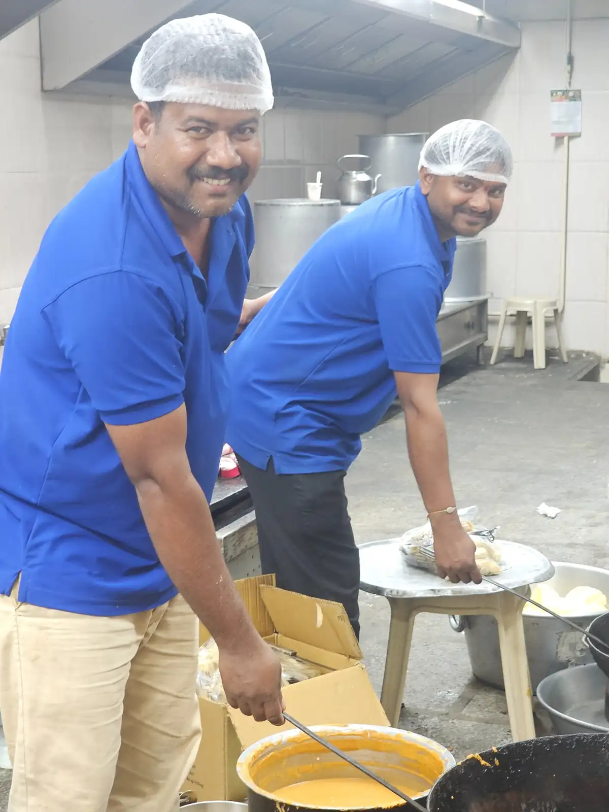 Traditional Andhra catering chefs working together in a large kitchen setup