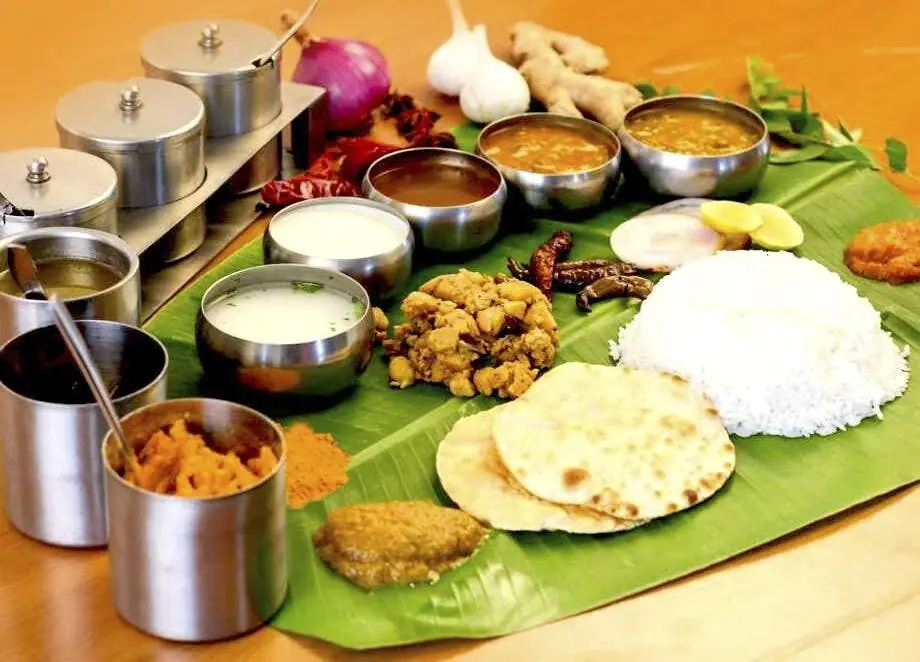 Traditional Andhra style catering meal served on banana leaf with rice, curries, chutneys and chapati in Bangalore