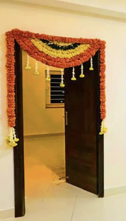 Marigold flower decor for bedroom door during griha pravesh in Bangalore