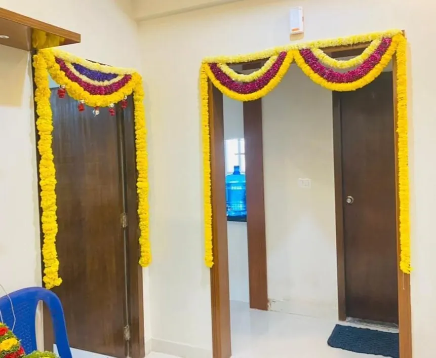 Bedroom door decor with colorful flower garlands for gruhapravesham ceremony in Bangalore