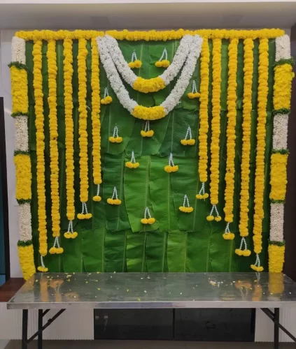 House warming homam puja flower decoration with traditional garlands and floral backdrop