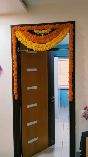 Bedroom door flower decorations for housewarming function in Bangalore.