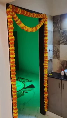 Traditional Indian flower decor for bedroom door during housewarming in Bangalore.