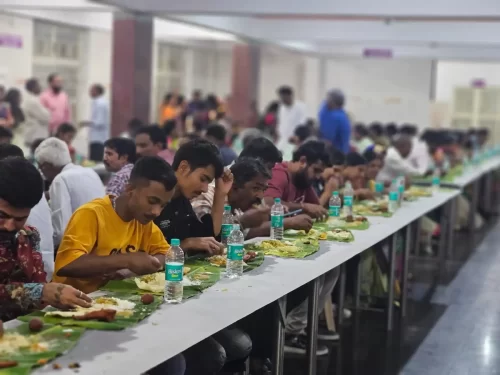 Caterers serving guests during live banana leaf dining service