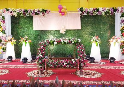 Grass backdrop naming ceremony floral decor organisers